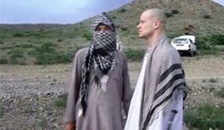 Sgt. Bowe Bergdahl, right, stands with a Taliban fighter in eastern Afghanistan. The Taliban on Wednesday, June 4, 2014, released a video showing the handover of Bergdahl to U.S. forces in eastern Afghanistan, touting the swap of the American soldier for five Taliban detainees from Guantanamo as a significant achievement for the insurgents. (Associated Press) ** FILE **