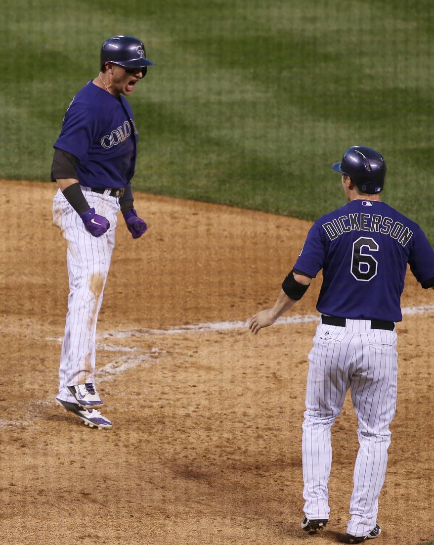 Colorado Rockies' Troy Tulowitzki (2) celebrates after scoring a run during the fifth inning of a baseball game against the Arizona Diamondbacks Wednesday, June 4, 2014, in Denver. (AP Photo/Jack Dempsey)