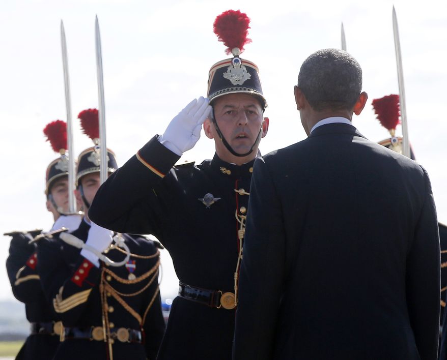 President Barack Obama is saluted by Platoon Commander Jean-Philippe Sauvaigo as he arrives at Orly Airport in Paris, France, Thursday, June 5, 2014. He will have dinner with French President Francois Hollande Thursday evening and attend 70th anniversary of D-Day at Normandy on Friday. (AP Photo/Charles Dharapak)