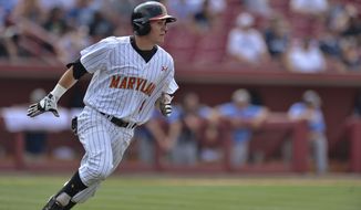 Maryland&#39;s Charlie White runs to first base after hitting an RBI single in the bottom of the ninth inning during an NCAA college baseball tournament regional game against Old Dominion in Columbia, S.C.,  Friday, May 30, 2014. Maryland won 4-3. (AP Photo/Richard Shiro)