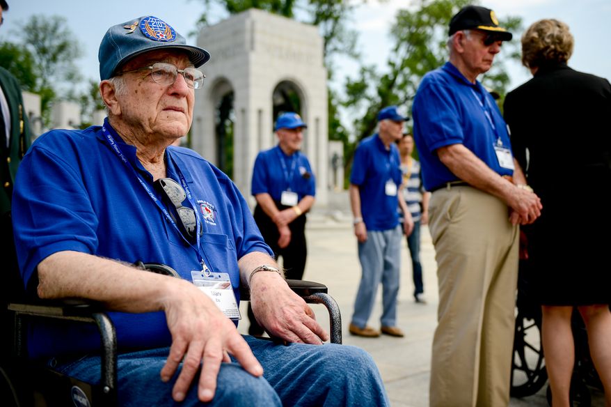 Retired Airforce Pfc. Marv Eis of Two Rivers, Wis., left, becomes emotional after shaking hands with Susan Eisenhower, left, the granddaughter of President Dwight D. Eisenhower who served as the Supreme Allied Commander in Europe during World War II, following a World War II Memorial ceremony on V-E Day commemorating the 69th anniversary of the Allied Forces Victory in the Atlantic and the end of World War II in Europe, Washington, D.C., Thursday, May 8, 2014. The ceremony was held by The Friends of the National World War II Memorial and the National Park Service. (Andrew Harnik/The Washington Times)
