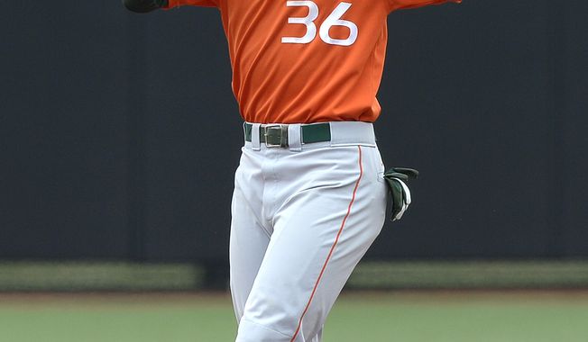 Miami&#x27;s Dale Carey reacts after being called out while trying to steal second base during the fifth inning of an NCAA college baseball tournament regional game against Oklahoma State, Sunday, June 2, 2013, in Louisville, Ky. Oklahoma State defeated Miami 7-1. (AP Photo/Timothy D. Easley)