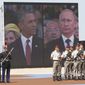 A large screen shows a picture of  Russian President Vladimir Putin, right, and U.S. President Barack Obama during the commemoration of the 70th anniversary of the D-Day in Ouistreham, western France, Friday, June 6, 2014. World leaders and veterans gathered by the beaches of Normandy on Friday to mark the 70th anniversary of World War Two&#39;s D-Day landings. (AP Photo/Christophe Ena, Pool)