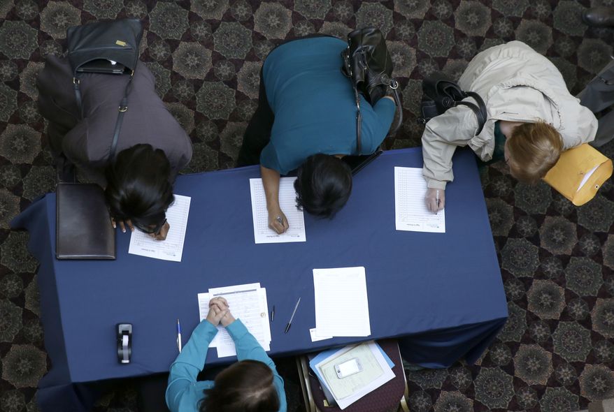 ** FILE ** In this Jan. 22, 2014, file photo, job seekers sign in before meeting prospective employers during a career fair at a hotel in Dallas. (AP Photo/LM Otero)