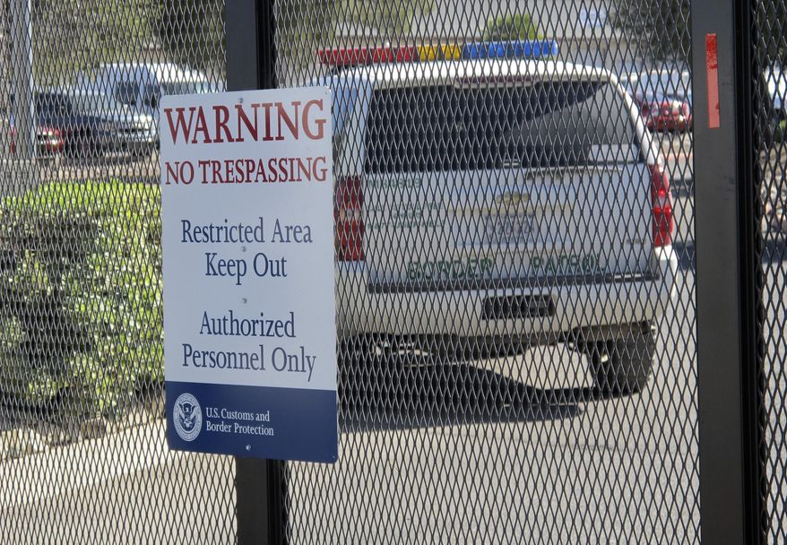 This photo shows the entrance to the U. S. Border Patrol facility on Saturday June 7, 2014, in Nogales, Ariz. Arizona officials said they are rushing federal supplies to this makeshift holding center in the southern part of the state that's housing hundreds of migrant children and is running low on the basics. (AP Photo/Brian Skoloff)