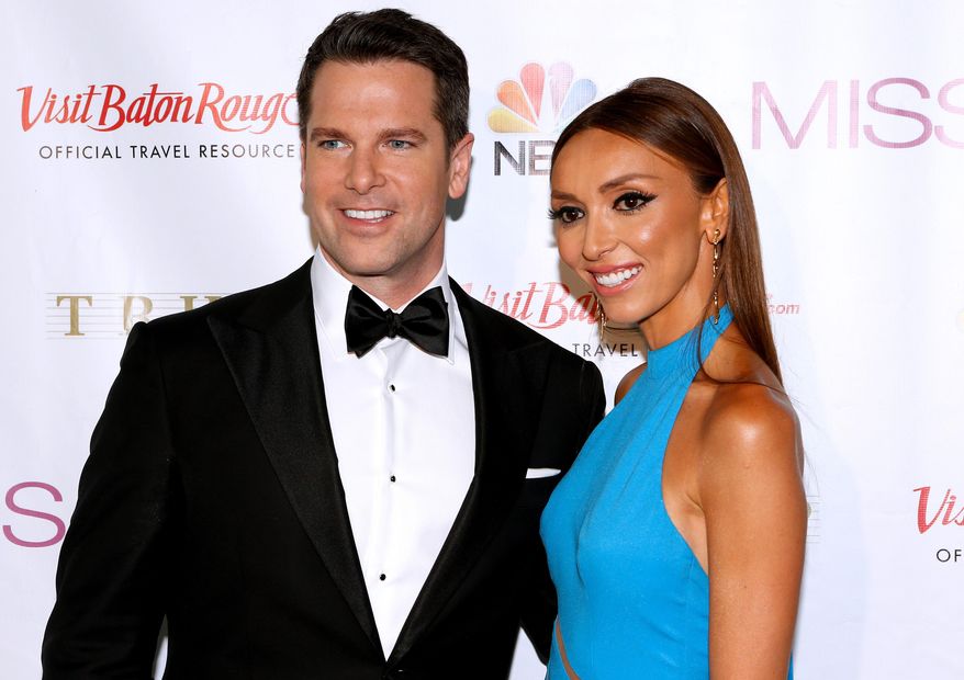 Pageant hosts Thomas Roberts, left, and Giuliana Rancic pose during a red carpet event before the Miss USA 2014 pageant in Baton Rouge, La., Sunday, June 8, 2014. (AP Photo/Jonathan Bachman)