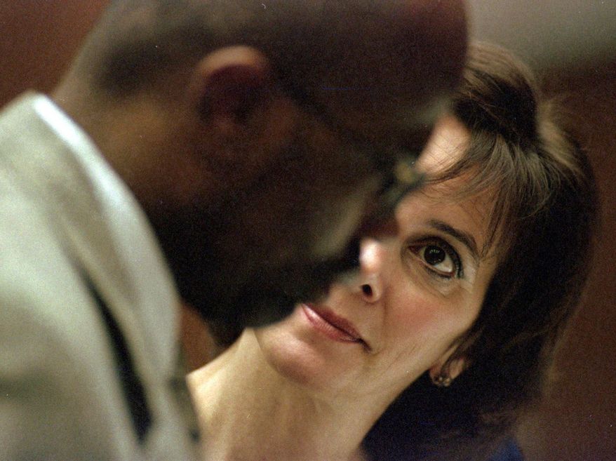 In this Sept. 8, 1995 file photo, Marcia Clark talks with co-prosecutor Christopher Darden during arguments about defense exhibits in the O.J. Simpson double-murder case in Los Angeles. (AP Photo/Eric Draper, Pool, File)