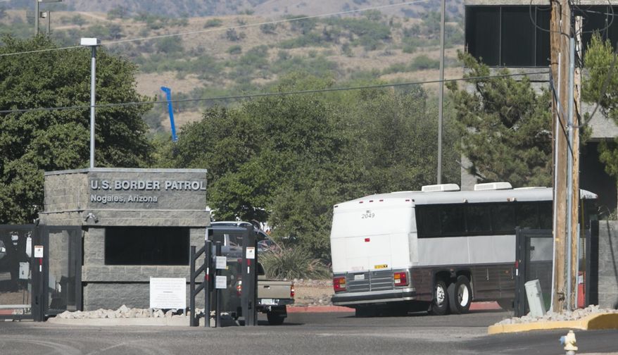 A bus carrying children arrives to a border patrol facility in Nogales, Ariz., Saturday, June 7, 2014. Arizona officials said that they are rushing federal supplies to a makeshift holding center in the southern part of the state that's housing hundreds of migrant children and is running low on the basics. (AP Photo/The Arizona Republic, Patrick Breen) MARICOPA COUNTY OUT; MAGS OUT; NO SALES