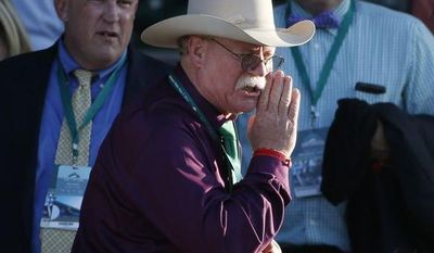 California Chrome co-owner Steve Coburn calls from the grandstand at Belmont Park after his horse finished fourth in the Belmont Stakes horse race, Saturday, June 7, 2014, in Elmont, N.Y. (AP Photo/Kathy Willens) 