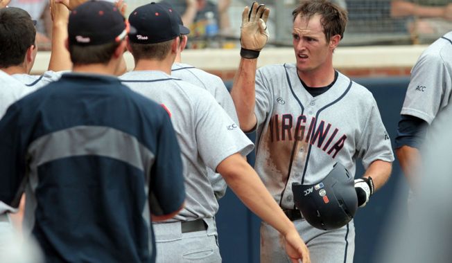 Virginia catcher Robbie Coman (8), right, celebrates scoring with teammates in the third inning of an NCAA college baseball tournament super regional game against Maryland in Charlottesville, Va., Sunday, June 8, 2014.  (AP Photo/Andrew Shurtleff)