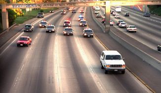 In this June 17, 1994 file photo, a white Ford Bronco, driven by Al Cowlings carrying O.J. Simpson, is trailed by Los Angeles police cars as it travels on a Southern California freeway in Los Angeles. Cowlings and Simpson led authorities on a chase after Simpson was charged with two counts of murder in the deaths of his ex-wife, Nicole Brown Simpson, and her friend, Ron Goldman. (AP Photo/Joseph Villarin, File)