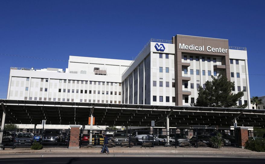 ** FILE ** This April 28, 2014, file photos shows the Phoenix VA Health Care Center in Phoenix. The Veterans Affairs Department says more than 57,000 patients are still waiting for initial medical appointments at VA hospitals and clinics 90 days or more after requesting them. An additional 64,000 who enrolled in the VA health care system over the past 10 years have never had appointments. (AP Photo/Ross D. Franklin, File)