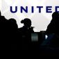 In this Saturday, Dec. 21, 2013, file photo, travelers check in at the United Airlines ticket counter at Terminal 1 in O&#39;Hare International Airport in Chicago. (AP Photo/Nam Y. Huh, File)