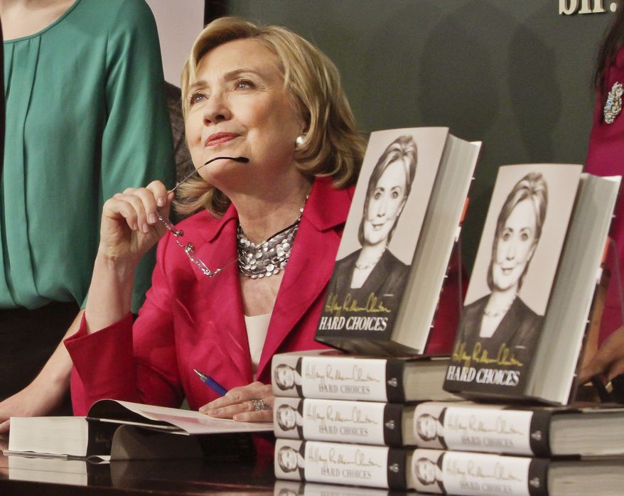 HiIlary Rodham Clinton listens before signing a copy of her book on Tuesday June 10, 2014, at Barnes and Noble bookstore in New York. Clinton said Tuesday that she and former President Bill Clinton "fully appreciate how hard life is for so many Americans," seeking to refine remarks she made about the pair being broke when they left the White House while on a high-profile media tour for a new book. (AP Photo/Bebeto Matthews)