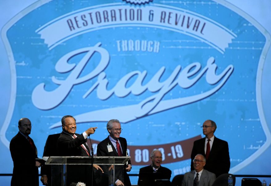 The Rev. Fred Luter Jr., at podium, president of the Southern Baptist Convention, smiles while addressing the convention during its annual meeting Tuesday, June 10, 2014, in Baltimore. The Southern Baptists are electing a new president to succeed the Rev. Fred Luter Jr., who became the denomination's first African-American president in 2012. Contenders include the Rev. Dennis Kim, pastor of a Korean church in Silver Spring, Maryland, and the Rev. Ronnie Floyd, pastor of Cross Church, with several locations in northwest Arkansas. The Southern Baptist Convention is the nation's largest Protestant denomination, with 15.7 million members, but leaders are concerned about recent membership declines. (AP Photo/Steve Ruark)
