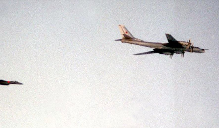 A U.S. Air Force F-15 Eagle escorts a Russian TU-95 Bear H strategic bomber, taking part in Russian military exercises, near Iceland on June 25, 1999. The appearance of Russian bombers over the Atlantic Ocean for the first time in years coincides with new efforts by Moscow to stop its once enormous military from disintegrating. This photo was released by the Department of Defense Thursday July 1, 1999 in Washington. (AP Photo/DOD Photo)