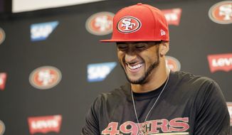 San Francisco 49ers quarterback Colin Kaepernick smiles as he answers question during an NFL football press conference on Wednesday, June 4, 2014, in Santa Clara, Calif. Kaepernick received a new six-year contract extension Wednesday that keeps him with the franchise through the 2020 season. (AP Photo/Marcio Jose Sanchez)