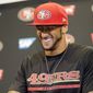 San Francisco 49ers quarterback Colin Kaepernick smiles as he answers question during an NFL football press conference on Wednesday, June 4, 2014, in Santa Clara, Calif. Kaepernick received a new six-year contract extension Wednesday that keeps him with the franchise through the 2020 season. (AP Photo/Marcio Jose Sanchez)