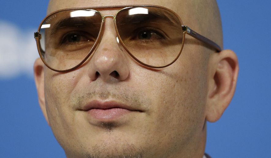 Cuban-American rapper Pitbull listens to a question during a news conference one day before the World Cup soccer tournament starts in Sao Paulo, June 11, 2014. (AP Photo/Felipe Dana) ** FILE **