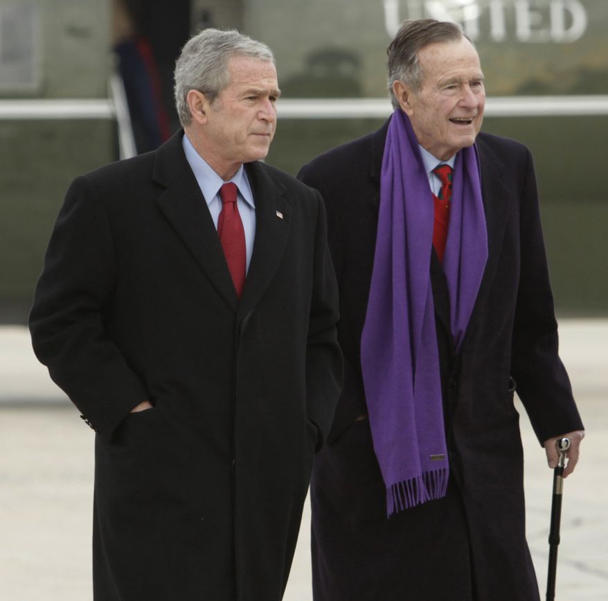 FILE - This Dec. 26, 2008 file photo shows then-President George W. Bush walking with his father, former President George H.W. Bush, at Andrews Air Force Base, Md. Turns out even former presidents can fall prey to hackers. A mysterious email hacker apparently accessed private photos and messages sent between members of the Bush family, including both retired commanders in chief. The Secret Service is investigating the breach, which appeared to yield little more than a few snapshots and some family discussions. But the incident illustrated how easily hackers can pry into private lives, even those of one of the nation's most prominent and closely guarded political clans. (AP Photo/Evan Vucci, File)