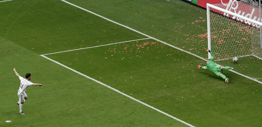 Spain's Xabi Alonso scores a penalty kick during the group B World Cup soccer match between Spain and the Netherlands at the Arena Ponte Nova in Salvador, Brazil, Friday, June 13, 2014. (AP Photo/Christophe Ena)