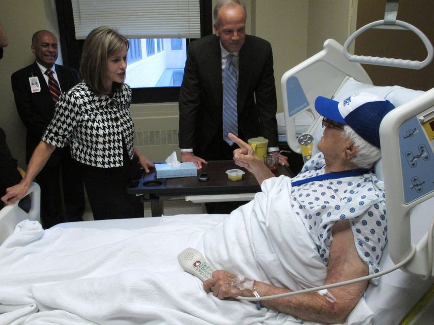 ** FILE ** Bob Brown, an 87-year-old World War II veteran from Perry Kan., speaks with U.S. Rep. Lynn Jenkins, left, and U.S. Sen. Jerry Moran, right, during their visit to the Colmery-O'Neil Veterans Affairs Medical Center, Friday, June 13, 2014, in Topeka, Kan. Some Kansas veterans can't get medical appointments at U.S. Veterans Affairs facilities and are having scheduled checkups canceled as the dates approach, the two members of the state's congressional delegation said after touring the in Topeka VA medical center. (AP Photo/John Hanna)