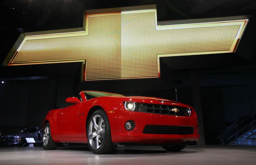 ** FILE ** In this Wednesday, Nov. 17, 2010, file photo, the 2011 Chevrolet Camaro convertible debuts at the Los Angeles Auto Show. General Motors is recalling nearly 512,000 Chevrolet Camaro muscle cars from the 2010 to 2014 model years. A driver's knee can bump the key and knock the switch out of the "run" position, causing an engine stall. (AP Photo/Reed Saxon, File)