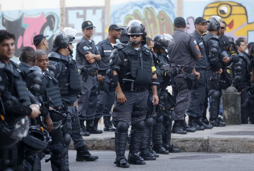 Police guard the streets near the Maracana stadium before the game between Argentina and Bosnia during the 2014 soccer World Cup in Rio de Janeiro, Brazil, Sunday, June 15, 2014. (AP Photo/Silvia Izquierdo)