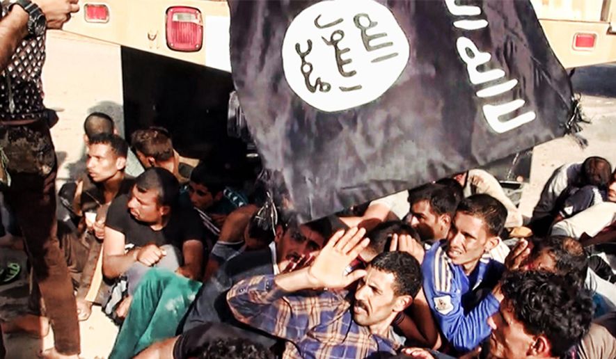 This image posted on a militant website on Saturday, June 14, 2014, which has been verified and is consistent with other AP reporting appears to show militants from the al-Qaeda-inspired Islamic State of Iraq and the Levant (ISIL) with captured Iraqi soldiers wearing plain clothes after taking over a base in Tikrit, Iraq. (AP Photo via militant website)