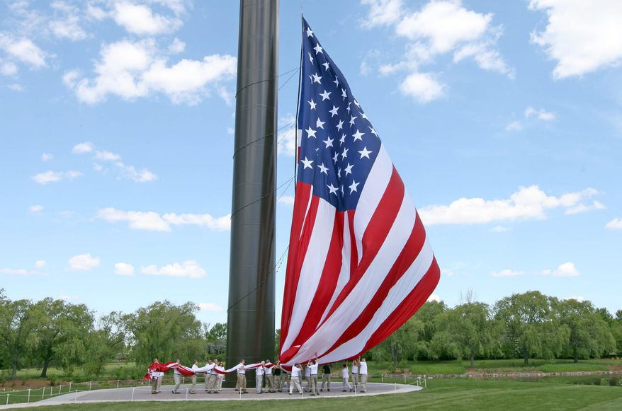 Acuity insurance company employees who are military veterans work to raise the American flag up the 400-foot flagpole during the dedication Monday June 16, 2014, in Sheboygan, Wis. The Sheboygan-based insurance company says it is the tallest flagpole in the country beating out the previous record holder, in Laredo, Texas, by nearly 100 feet. (AP Photo/Milwaukee Journal-Sentinel, Mike De Sisti )