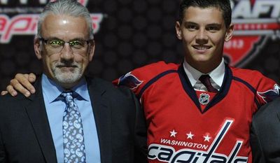 **FILE** Andre Burakovsky, a winger, stands with Washington Capitals scouting director Ross Mahoney (left) and coach Adam Oates (right) after being chosen 23rd overall in the first round of the NHL hockey draft, Sunday, June 30, 2013, in Newark, N.J. (AP Photo/Bill Kostroun)
