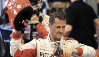 ** FILE ** In this Sunday, Dec. 16, 2012, file photo, Michael Schumacher of Germany finishes a test drive prior to the Race of Champions at Rajamangala national stadium in Bangkok, Thailand. (AP Photo/Apichart Weerawong, File)