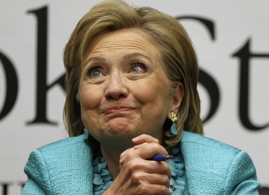 Former Secretary of State Hillary Rodham Clinton listens to a customer signing copies of her new book "Hard Choices," at Harvard Book Store, Monday, June 16, 2014, in Cambridge, Mass. (AP Photo/Steven Senne)