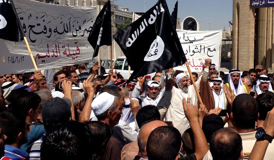 Demonstrators chant pro-al-Qaida-inspired Islamic State of Iraq and the Levant (ISIL) as they wave al-Qaida flags in front of the provincial government headquarters in Mosul, 225 miles (360 kilometers) northwest of Baghdad, Iraq, Monday, June 16, 2014. Sunni militants captured a key northern Iraqi town along the highway to Syria early on Monday, compounding the woes of Iraq&#39;s Shiite-led government a week after it lost a vast swath of territory to the insurgents in the country&#39;s north. (AP Photo)