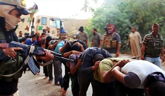 FILE - This file image posted on a militant website on Saturday, June 14, 2014, which has been verified and is consistent with other AP reporting, appears to show militants from the al-Qaida-inspired Islamic State of Iraq and the Levant leading away captured Iraqi soldiers dressed in plain clothes after taking over a base in Tikrit, Iraq. Iraq&amp;#8217;s military has been deeply shaken by their humiliating collapse in the face of an onslaught by Islamic militants the past two weeks. Officers talk of hardly being able to live with the shame. Commanders are under investigation for abandoning their posts. The impact is hurting efforts to rally the armed forces to fight back, with Shiite militiamen filling the void. (AP Photo via militant website, File)