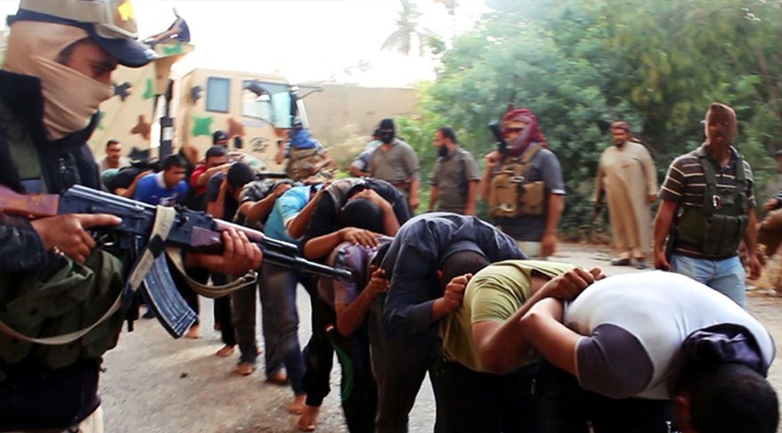 FILE - This file image posted on a militant website on Saturday, June 14, 2014, which has been verified and is consistent with other AP reporting, appears to show militants from the al-Qaida-inspired Islamic State of Iraq and the Levant leading away captured Iraqi soldiers dressed in plain clothes after taking over a base in Tikrit, Iraq. Iraq’s military has been deeply shaken by their humiliating collapse in the face of an onslaught by Islamic militants the past two weeks. Officers talk of hardly being able to live with the shame. Commanders are under investigation for abandoning their posts. The impact is hurting efforts to rally the armed forces to fight back, with Shiite militiamen filling the void. (AP Photo via militant website, File)