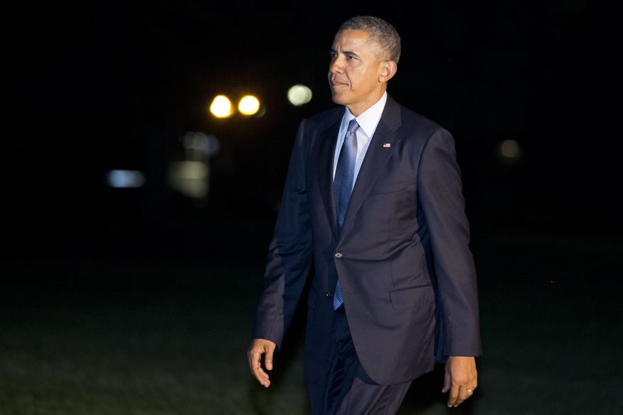President Barack Obama walks across the South Lawn on his return to the White House from a trip to Pittsburgh and New York City, Tuesday, June 17, 2014 in Washington. (AP Photo/Jacquelyn Martin)