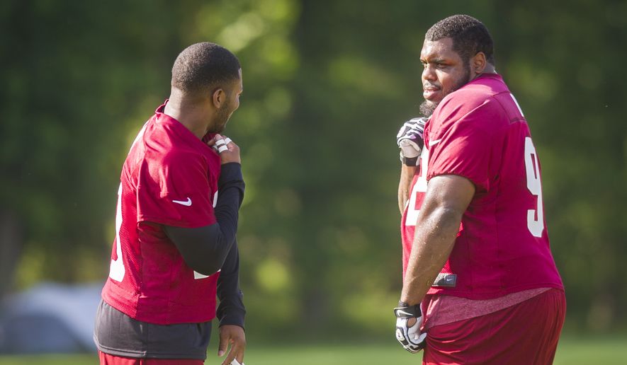 Washington Redskins safety Ryan Clark (21) shares a light moment with teammate, defensive lineman Chris Baker (92) on the practice field during mini camp practice at Redskins Park in Ashburn, Va., Wednesday, June 18, 20124. (Photo Rod Lamkey Jr.)
