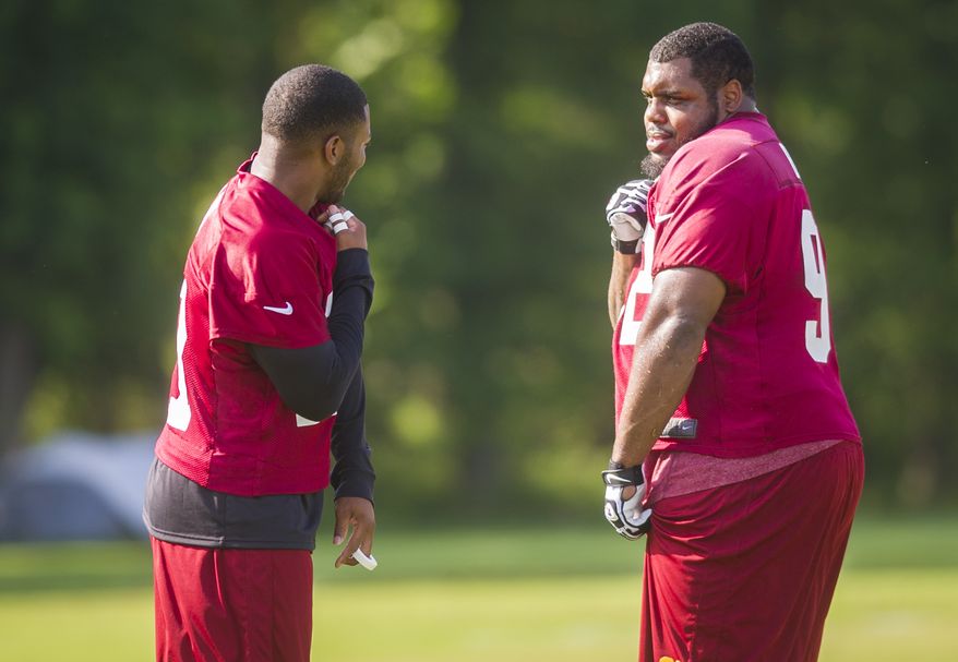 Washington Redskins safety Ryan Clark (21) shares a light moment with teammate, defensive lineman Chris Baker (92) on the practice field during mini camp practice at Redskins Park in Ashburn, Va., Wednesday, June 18, 20124. (Photo Rod Lamkey Jr.)