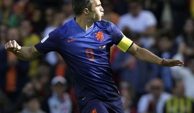 Netherlands&#39; Robin van Persie celebrates after scoring his side&#39;s second goal during the group B World Cup soccer match between Australia and the Netherlands at the Estadio Beira-Rio in Porto Alegre, Brazil, Wednesday, June 18, 2014.  (AP Photo/Fernando Vergara)