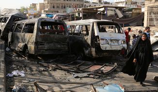 Iraqi civilians inspect damage in the aftermath of a Tuesday car bombing that killed many people and wounded tens of others in a crowded outdoor market, in Baghdad&#39;s Sadr City, Iraq, Wednesday, June 18, 2014. (AP Photo/Karim Kadim)