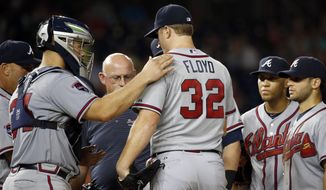 Atlanta Braves manager Fredi Gonzalez, far left, catcher Evan Gattis, head athletic trainer Jeff Porter look at starting pitcher Gavin Floyd, with shortstop Andrelton Simmons and second baseman Tommy La Stella, during the seventh inning of a baseball game against the Washington Nationals at Nationals Park Thursday, June 19, 2014, in Washington. Floyd left the game. The Braves won 3-0. Atlanta Braves right-hander Gavin Floyd left Thursday night&#39;s game against the Washington Nationals with an elbow injury in his ninth start since returning from Tommy John surgery.(AP Photo/Alex Brandon)