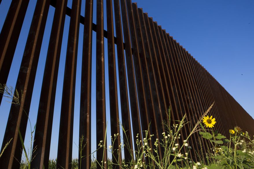 This June 10, 2014 photo shows the 18-foot, rust-colored steel U.S-Mexico border fence stands by The Nature Conservancy affecting the organization wildlife conservancy efforts in Brownsville, Texas. The federal government recently spent $3 million to purchase 1,119 acres of the well-managed land for the benefit of the ocelot after damaging the endangered species' habitat to build 70 miles of fences along the border with Mexico. (AP Photo/Houston Chronicle, Marie D. De Jesus)