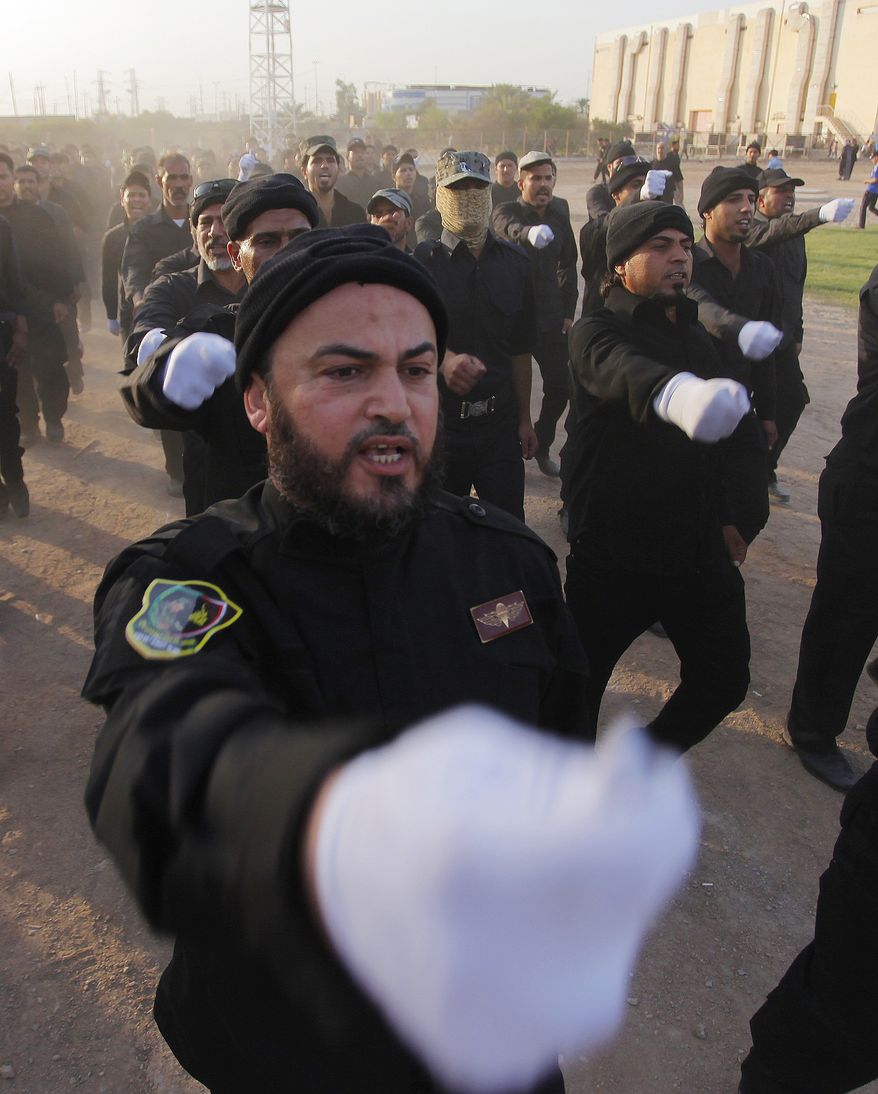Volunteers in the newly formed "Peace Brigades" participate in a parade near the Imam Ali shrine in the southern holy Shiite city of Najaf, Iraq, Thursday, June 19, 2014, after called for by the radical Shiite cleric Muqtatda al-Sadr to form brigades to protect Shiite holy shrines against possible attacks by Sunni militants. (AP Photo/Jaber al-Helo)