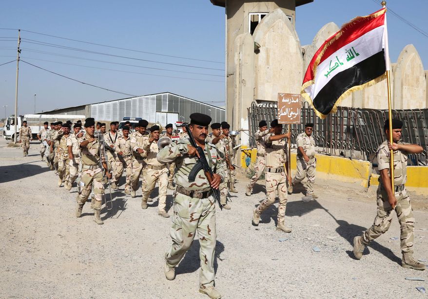 Iraqi Army soldiers parade inside the main army recruiting center during a recruiting drive for men to volunteer for military service in Baghdad, Iraq, Thursday, June 19, 2014, after authorities urged Iraqis to help battle insurgents. The campaign by the al-Qaida-inspired Islamic State militants has raised the specter of the sectarian warfare that nearly tore the country apart in 2006 and 2007, with the popular mobilization to fight the insurgents taking an increasingly sectarian slant, particularly after Iraq's top Shiite cleric made a call to arms on Friday. (AP Photo/Karim Kadim)y the country's top Shiite cleric to join the fight against Sunni militants advancing in the north. (AP Photo/ Karim Kadim)