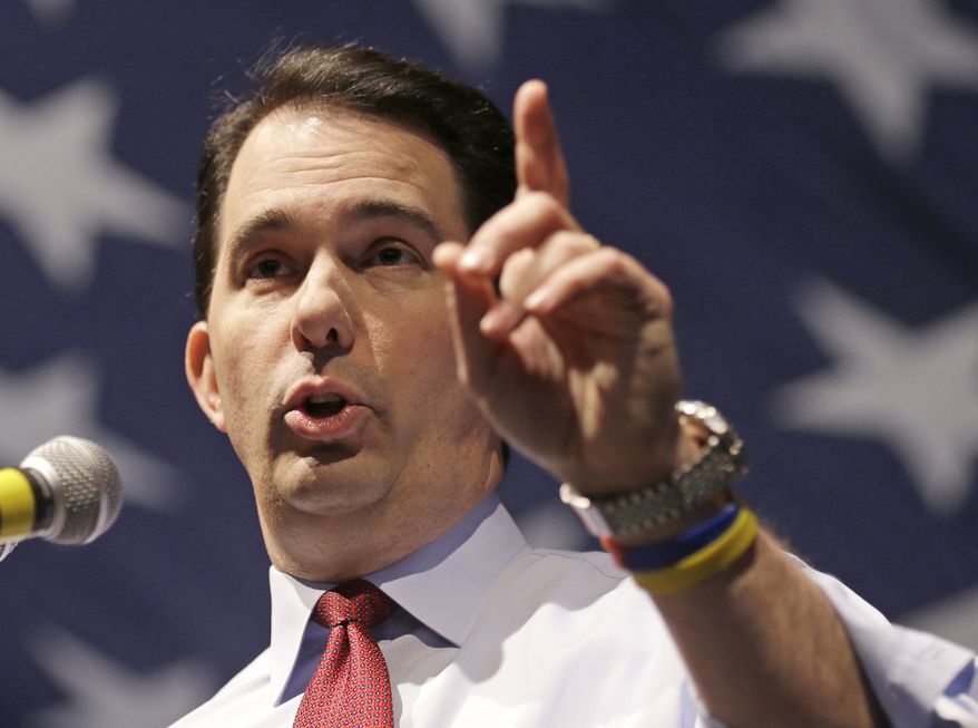 FILE - In this May 3, 2014, file photo, Wisconsin Republican Gov. Scott Walker speaks in Milwaukee. Newly released documents show prosecutors are alleging Walker was at the center of a nationwide "criminal scheme" to illegally coordinate with outside conservative groups. The documents were filed as part of an ongoing lawsuit challenging the probe by the conservative group Wisconsin Club for Growth. The documents were ordered publicly released Thursday, June 19, 2014, by a federal appeals court judge after prosecutors and the Wisconsin Club for Growth did not object. (AP Photo/Jeffrey Phelps, File)