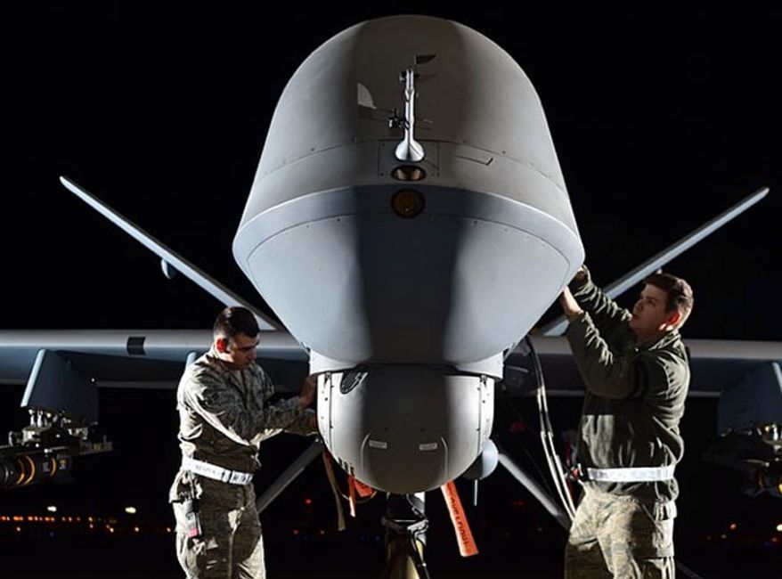 U.S. airmen prepare an MQ-9 Reaper for flight during exercise Combat Hammer, May 15, 2014, at Creech Air Force Base, Nev. (U.S. Air Force)