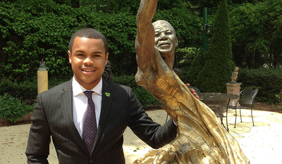 The author standing next to statue of Nelson Mandela in Maya Angelou’s sculpture garden at her Winston-Salem home.