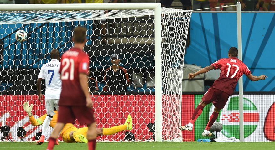 Portugal's Nani, right, scores the opening goal during the group G World Cup soccer match between the USA and Portugal at the Arena da Amazonia in Manaus, Brazil, Sunday, June 22, 2014. (AP Photo/Paulo Duarte)