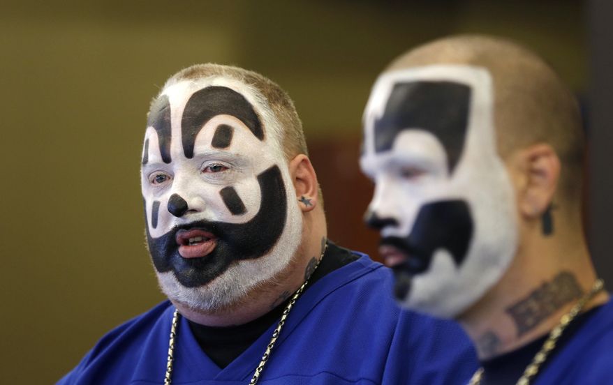 FILE --In this Jan. 8, 2014 file photo, Joseph Bruce, aka Violent J, left, and Joseph Utsler, aka Shaggy 2 Dope, members of the Insane Clown Posse, address the media in Detroit. The U.S. Justice Department is asking a judge to dismiss a lawsuit by Insane Clown Posse, which objects to a report that describes its fans as a dangerous gang. A Detroit federal judge holds a hearing Monday, June 23, 2014. The government says the rap-metal duo from the Detroit area and its fans have no standing to sue. (AP Photo/Carlos Osorio)